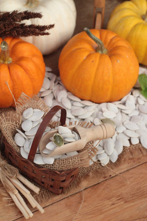 Pumpkin with pumpkin seeds on wood backgroundの写真素材