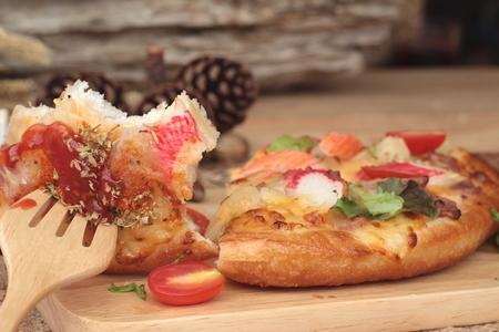 Italian pizza is delicious on wood backgroundの写真素材