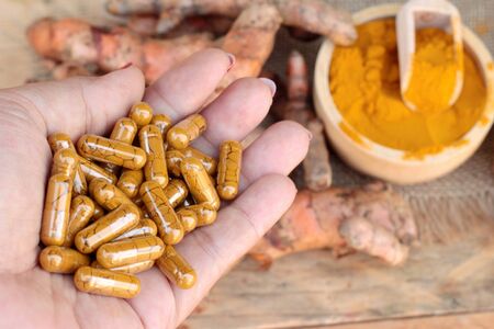 Turmeric powder with tumeric capsules for healthの写真素材