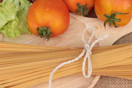 Raw spaghetti on wood backgroundの写真素材
