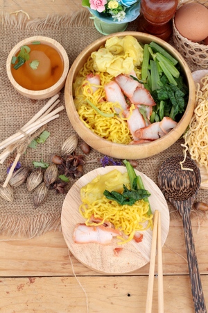 Egg noodles with pork and dumpling in soupの写真素材