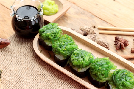 Sushi roll and seaweed salad is deliciousの写真素材