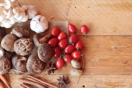 Mushrooms and vegetables on wood backgroundの写真素材