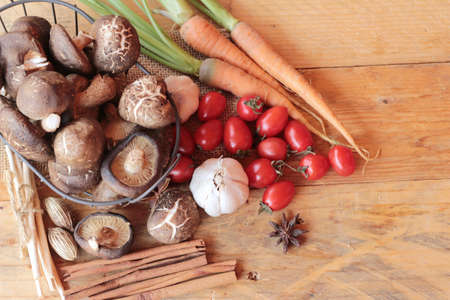 Mushrooms and vegetables on wood backgroundの写真素材
