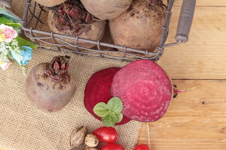 Fresh beetroot with slices on wood backgroundの写真素材