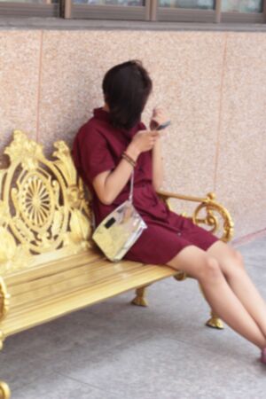 blur woman using smart phone in the parkの写真素材