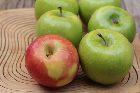 green and red apples on wood backgroundの写真素材