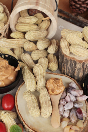 Peanut butter and peanut on wood background