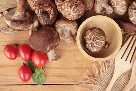 Shiitake mushrooms for cooking on wood backgroundの写真素材