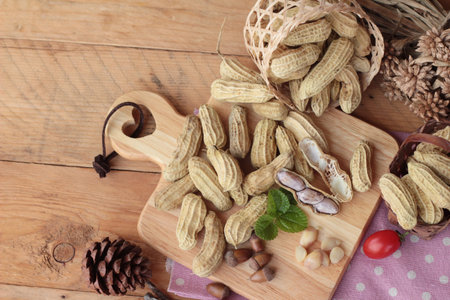 Peanut and boiled peanuts on wood background