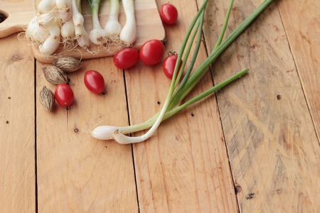 Fresh green onions on wood backgroundの写真素材