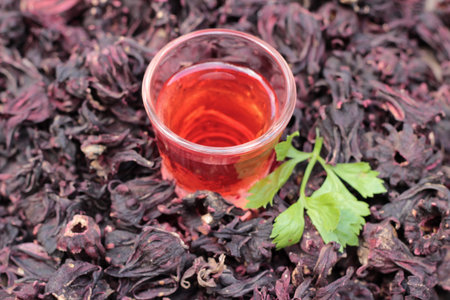Dry roselle and roselle juice on wood background