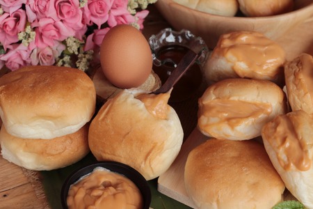 bread with custard delicious on wood backgroundの写真素材