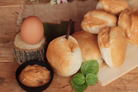 bread with custard delicious on wood backgroundの写真素材