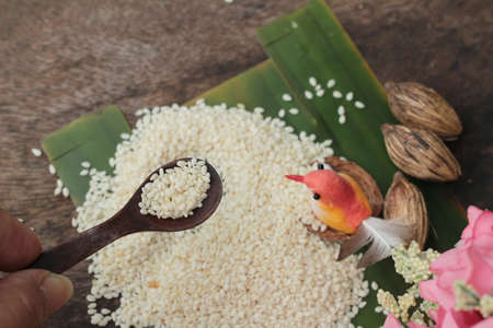 White sesame seeds organic on wood backgroundの写真素材