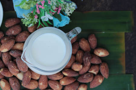 Almond milk with almond on wood backgroundの写真素材
