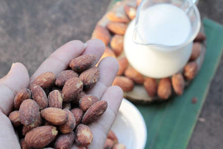 Almond milk with almond on wood backgroundの写真素材