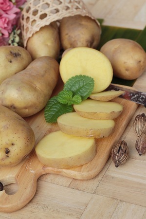 Potatoes raw vegetables with slices for cookingの写真素材