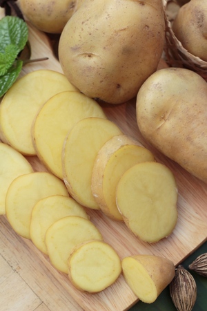 Potatoes raw vegetables with slices for cookingの写真素材