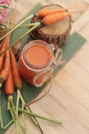 Carrot juice and fresh carrot vegetables organicの写真素材