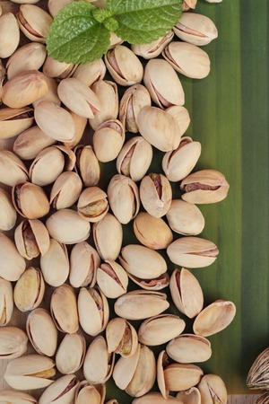 Pistachio nuts is tasty on wood backgroundの写真素材