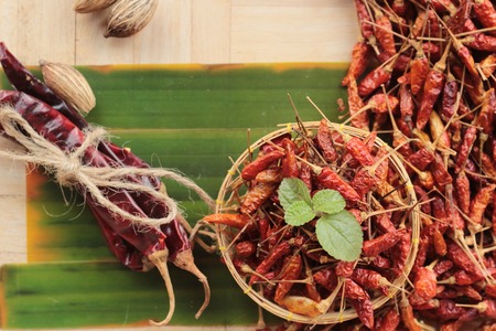 Dried red chili peppers on wood backgroundの写真素材