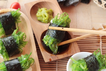 Sushi roll and seaweed salad is deliciousの写真素材