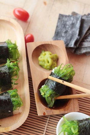 Sushi roll and seaweed salad is deliciousの写真素材