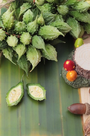 Bitter melon and sliced on wood backgroundの写真素材