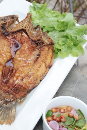 Fried snapper with fish sauce and spicy salad