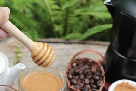 Coffee with milk and honey is deliciousの写真素材