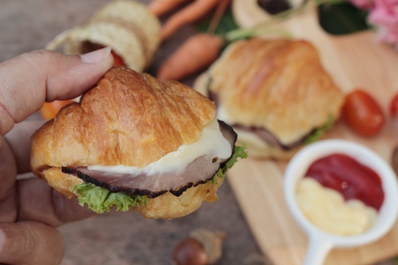 Croissant sandwich with grill pork, vegetable and cheeseの写真素材