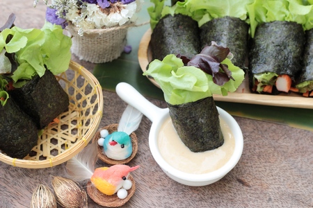 Fresh vegetable salad roll with seaweed and dressingの写真素材