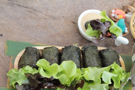 Fresh vegetable salad roll with seaweed and dressingの写真素材