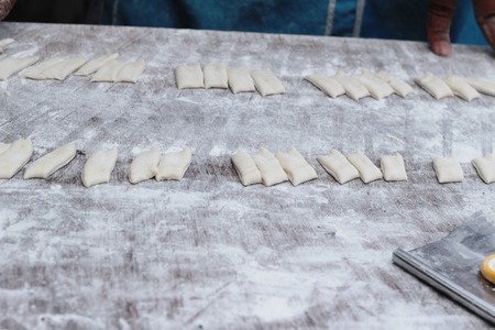 Making deep-fried dough stick in marketの写真素材