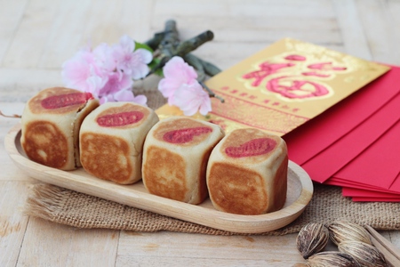 Festival moon cake with red envelopes, Chinese New Yearの写真素材