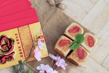 Festival moon cake with red envelopes, Chinese New Yearの写真素材
