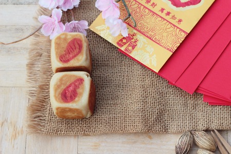 Festival moon cake with red envelopes, Chinese New Yearの写真素材