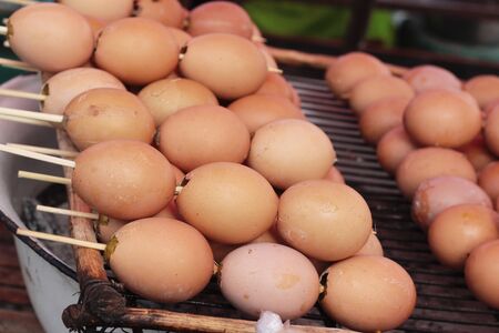 egg grilled on the sticks at stoveの写真素材
