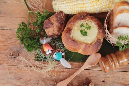Corn soup in bread bowl with fresh cornの写真素材