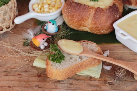 Corn soup in bread bowl with fresh cornの写真素材