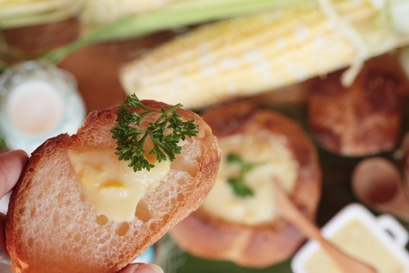Corn soup in bread bowl with fresh cornの写真素材