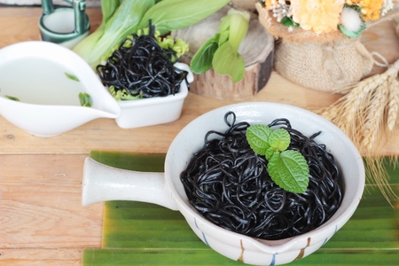 black noodles with pork and dumpling delicious.の写真素材