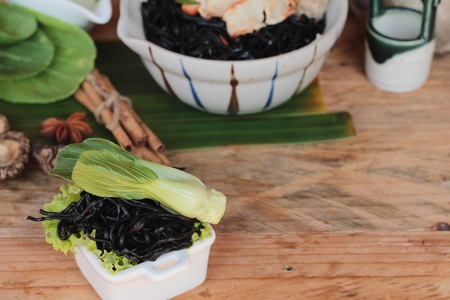 black noodles with pork and dumpling delicious.の写真素材