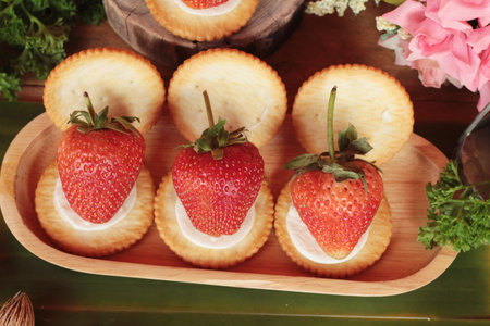 Biscuits with cream cheese and fresh strawberryの写真素材