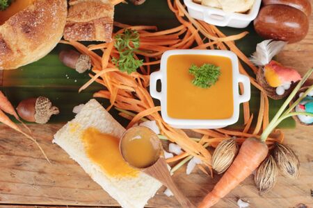Carrot cream soup with bread is deliciousの写真素材