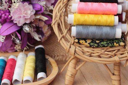 Colorful thread for sewing on wood background