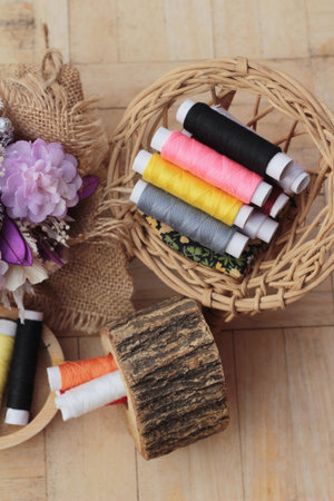 Colorful thread for sewing on wood background