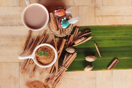 cinnamon powder and sticks on wood backgroundの写真素材