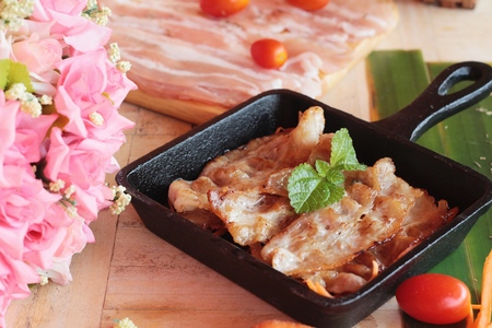 Pork bacon grilled on pan and fresh porkの写真素材